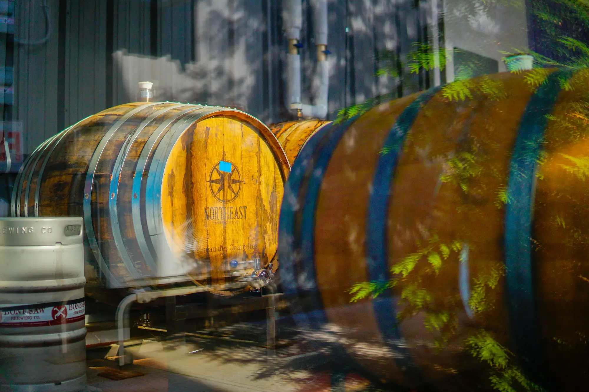 Oak fermentation barrels and a steel beer keg inside a craft brewery, the kind of business that often borrows interest-only while it grows