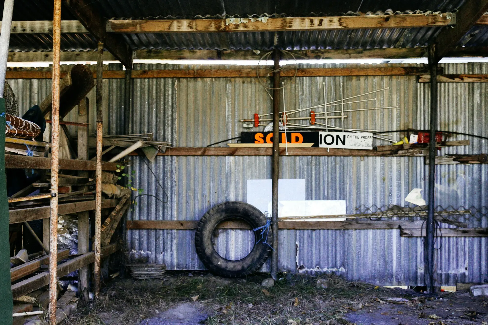 Australian farmer at a machinery shed with tractor