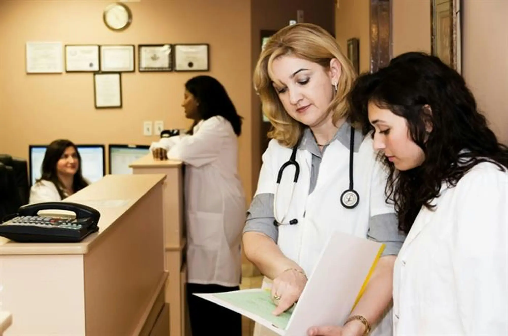 Physiotherapy or allied health clinic reception with practitioner and client